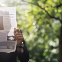 Person Reading Newspaper