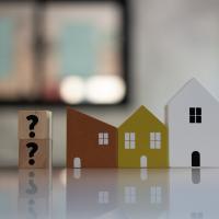 Picture of houses with question marks